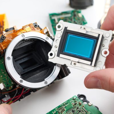 Image sensor digital SLR camera in hands of service engineer